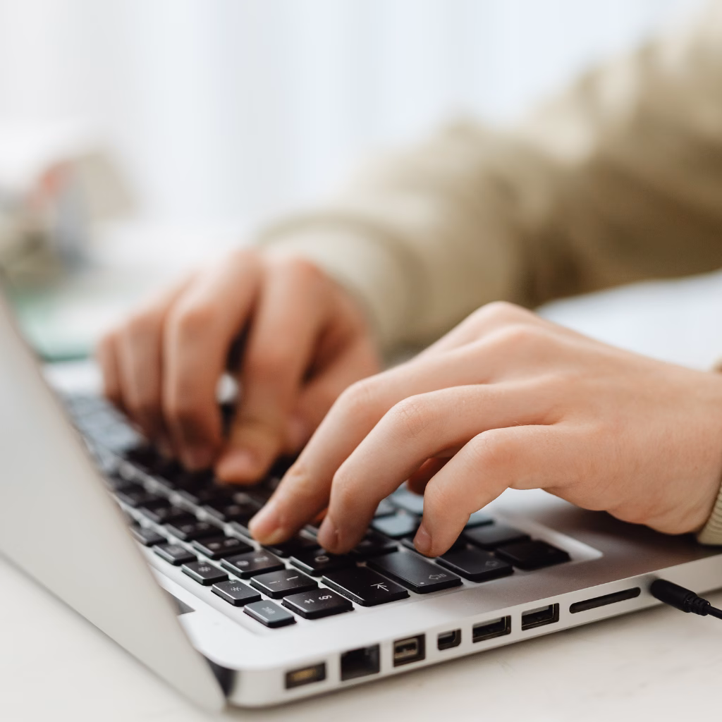 Contact us Hands typing on a computer keyboard